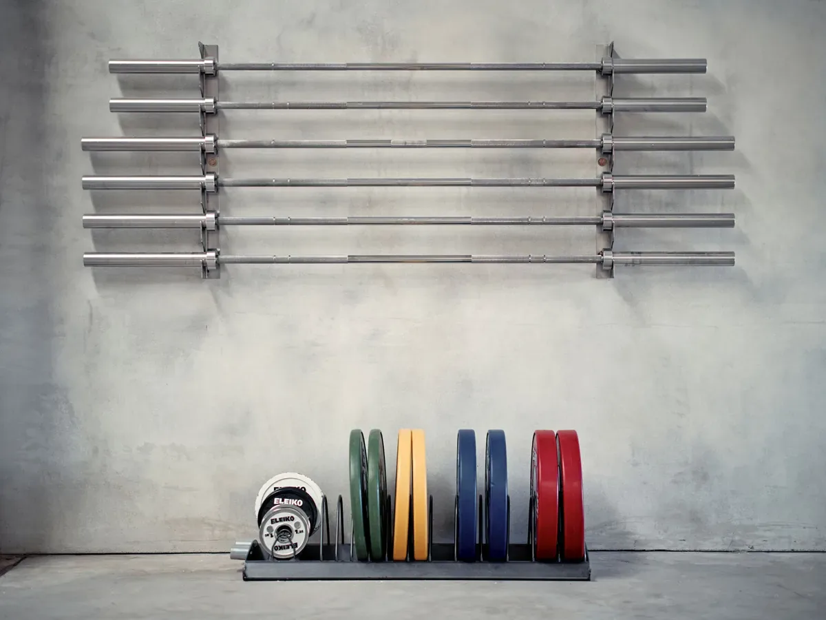 Racked barbells and colour-coded bumper plates in The Bailey