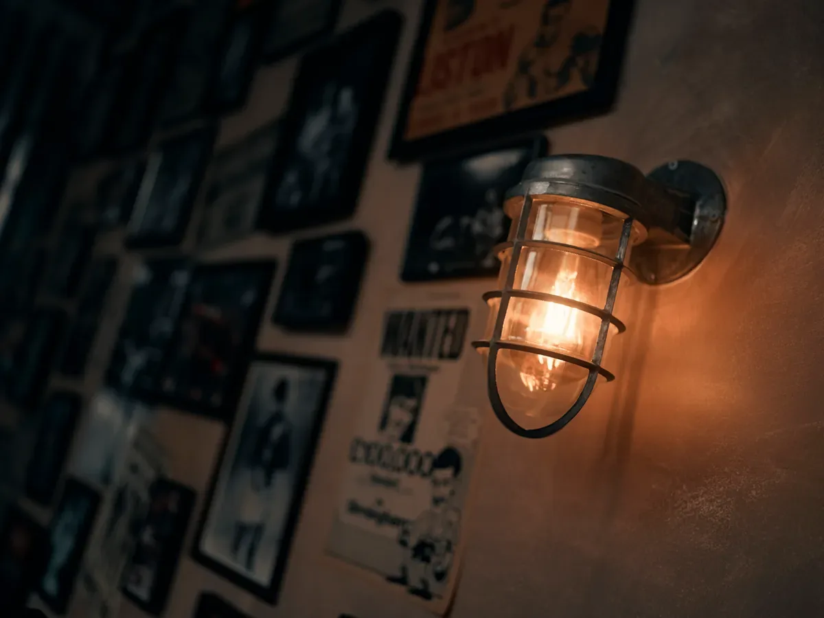 Bulkhead lighting over a wall of vintage boxing posters in The Bowery