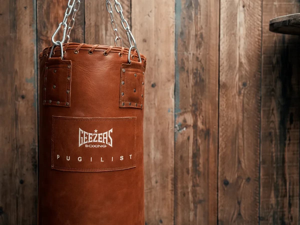 Leather heavy bag hung against reclaimed wood panelling in The Bowery