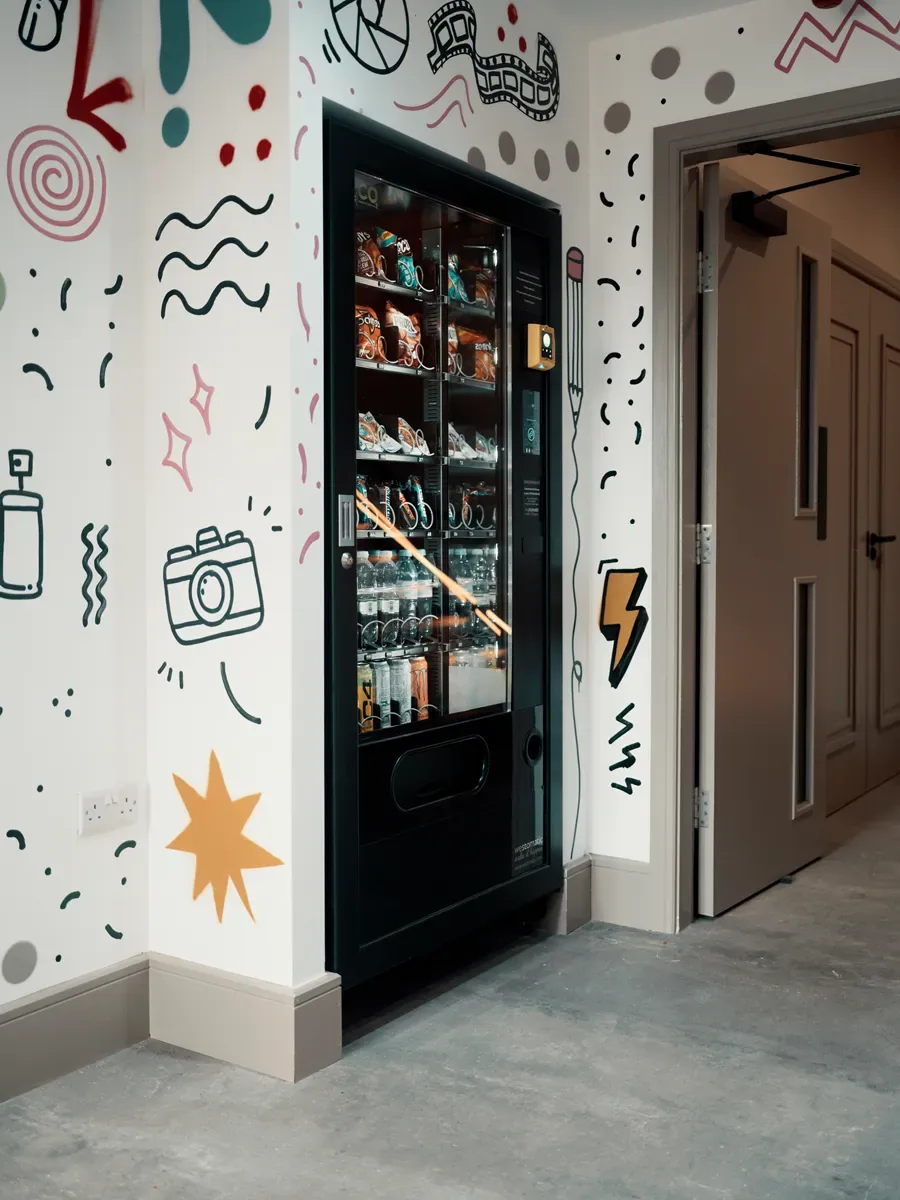 Vending machine in the graffiti-lined snack nook