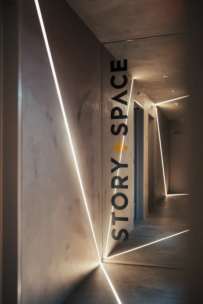 Mirrored corridor with angular LED strip lighting