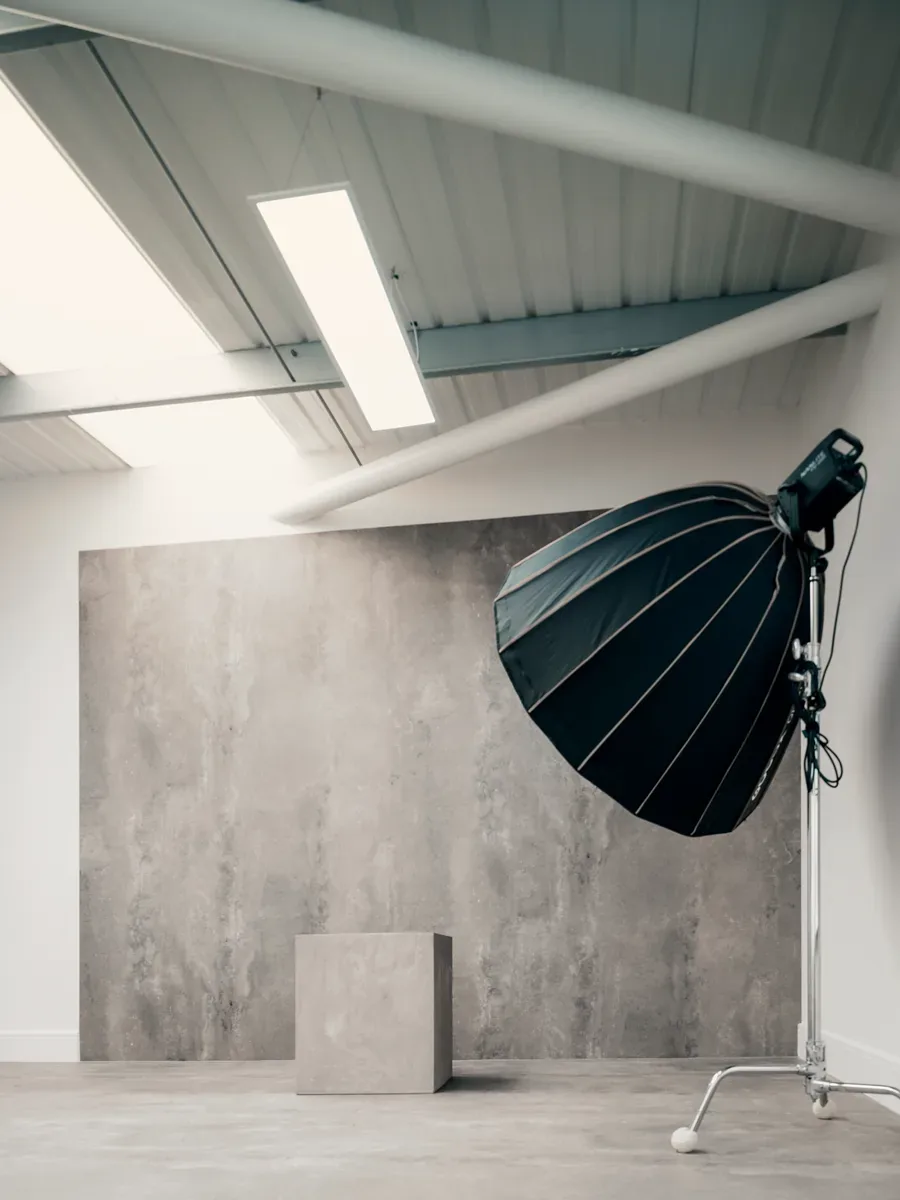 Concrete backdrop wall lit with a parabolic softbox in The Loft