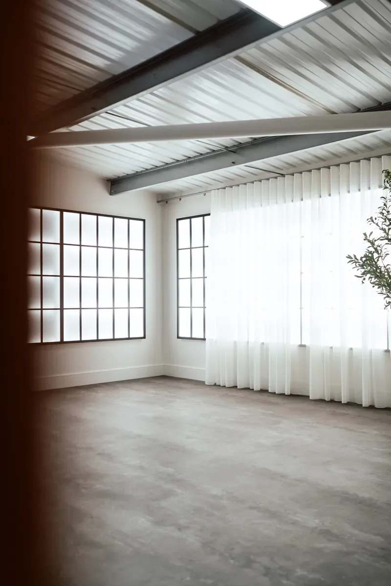 The open floor and Crittall-style windows of The Loft flooded with natural light