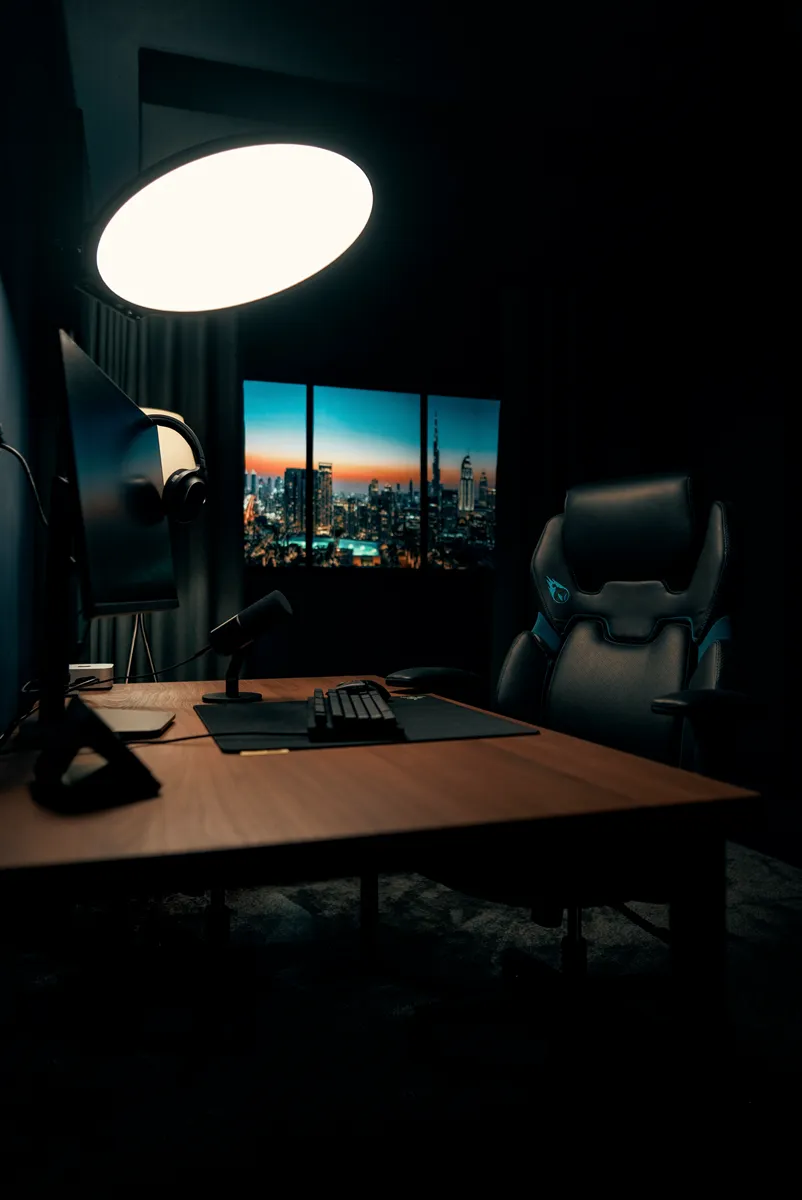 Gaming chair at the desk beneath the halo light, skyline window behind, in Ready Player One