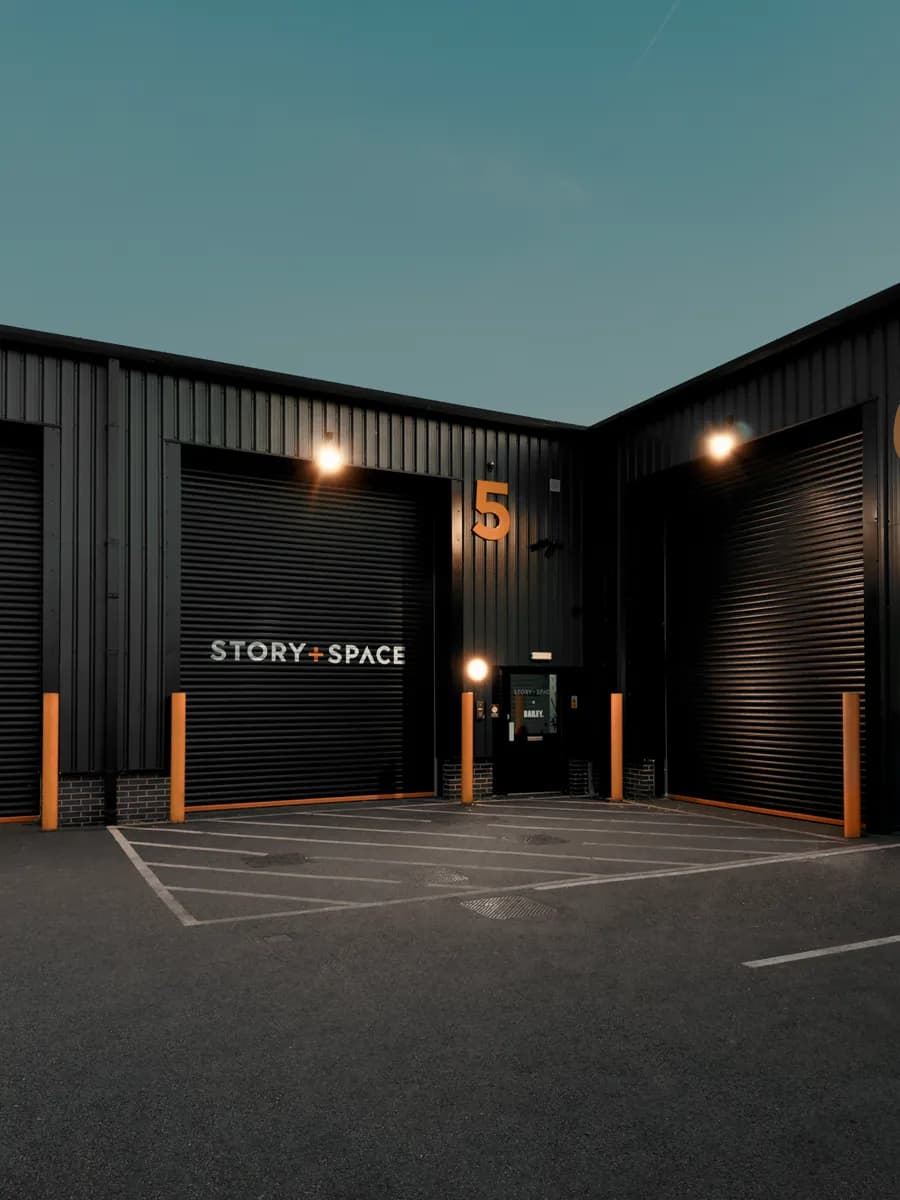 Story + Space at Unit 5, Quayside Court: black shutters with the Story + Space sign and the entrance door beside it