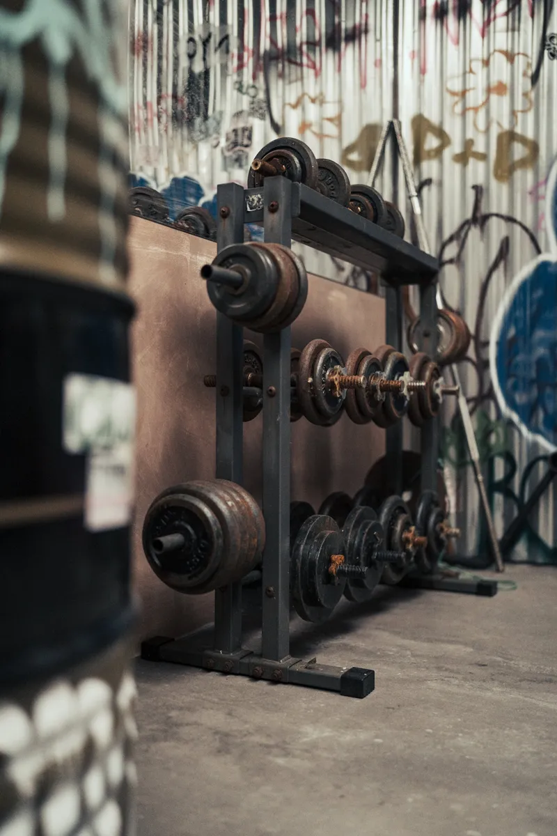 Vintage weights rack against the graffiti wall in The Bowery