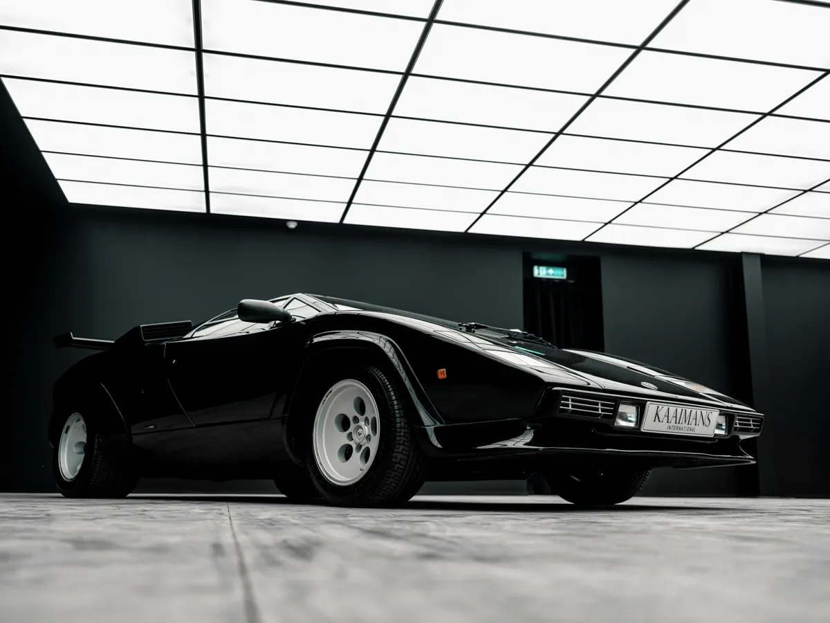 Lamborghini Countach shot low under the illuminated ceiling in The Neon